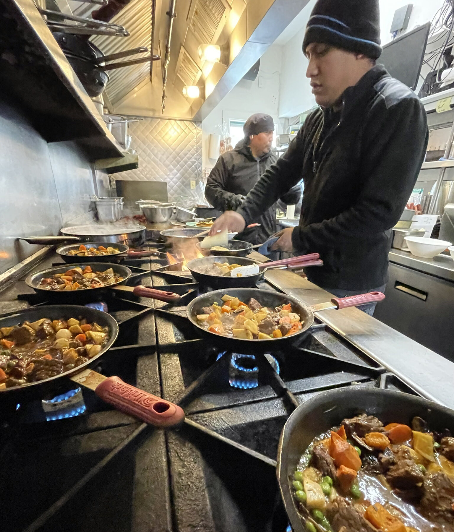 A volunteer cooking warm meals at The Warming Place, providing nourishment and care for Nantucket’s unhoused community