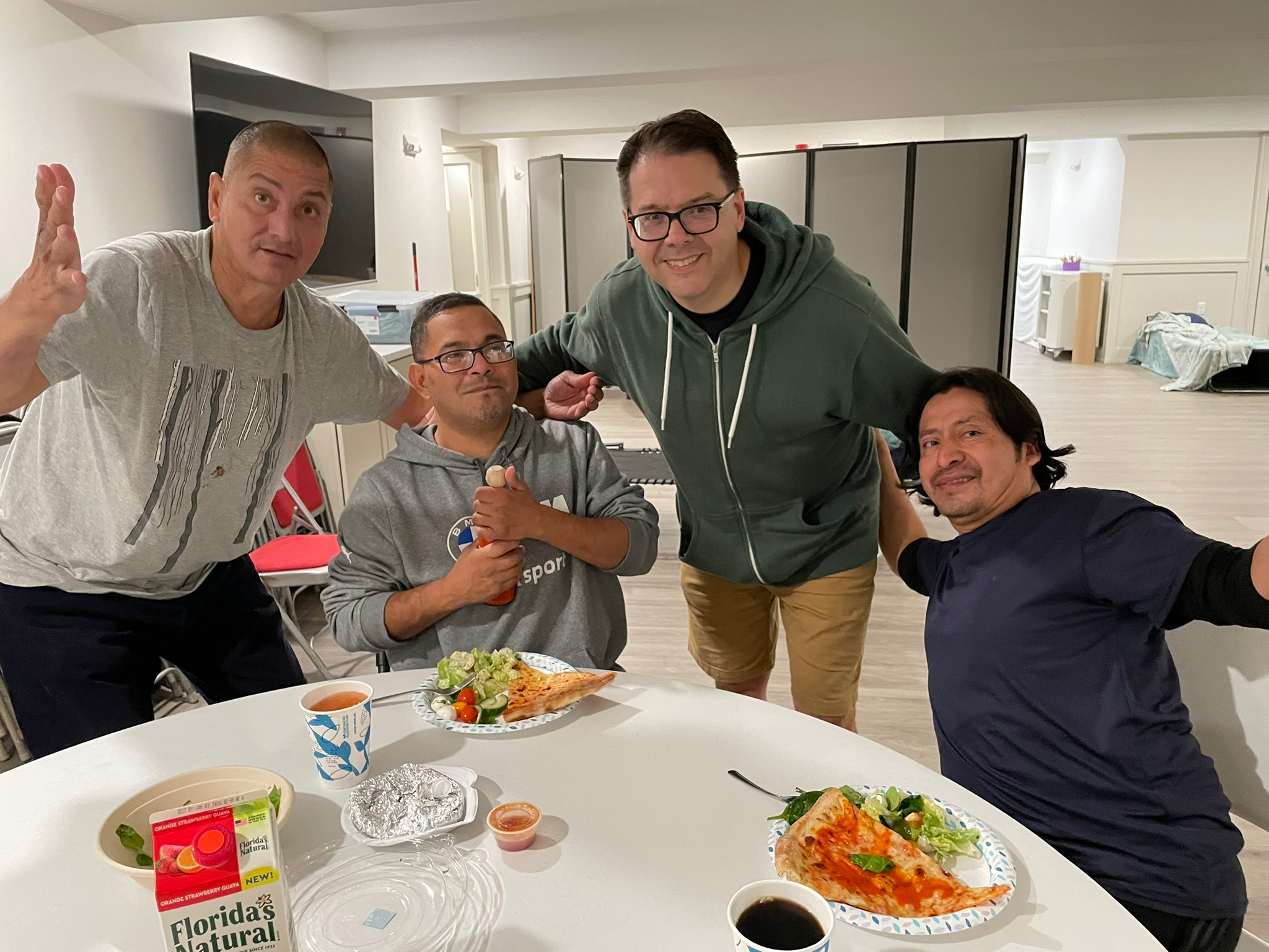 People experiencing homelessness at The Warming Place enjoying meals and support in a safe, caring environment