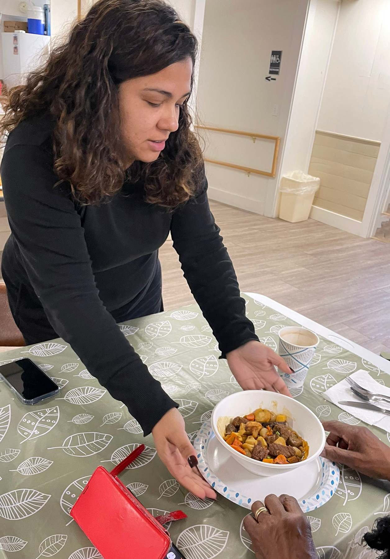 A volunteer preparing warm meals at The Warming Place for Nantucket residents experiencing homelessness